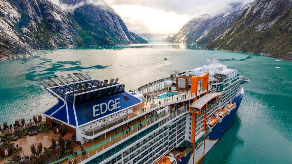 A cruise ship in a bay surrounded by mountains