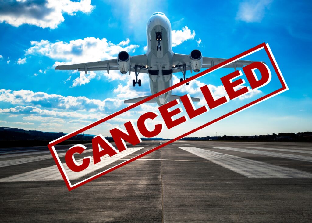 An airplane with a stamp over it that reads "cancelled"